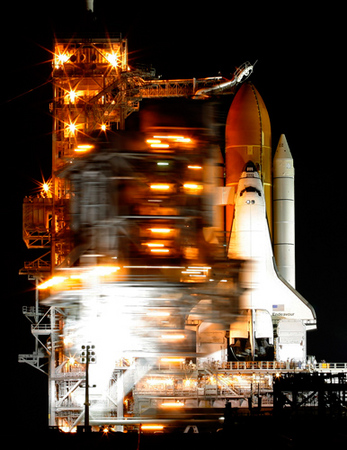 The rotating service structure rolls back in preparation for the launch of the Space Shuttle Endeavour.